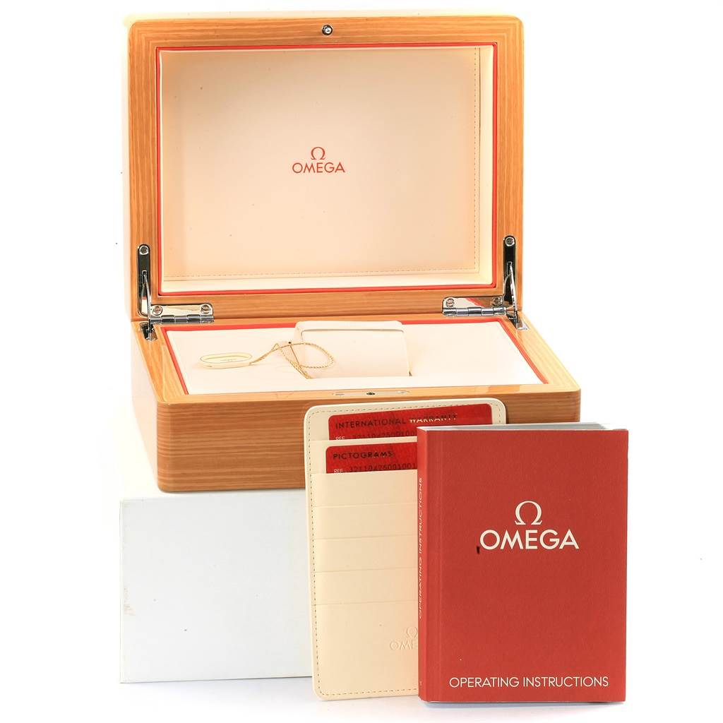 The image shows a wooden Omega Speedmaster 321.10.42.50.01.001 Men
s Stainless Steel Black Dial 321.10.42.50.01.001 Men
s Stainless Steel Black Dial watch box with operating instructions, an international warranty card, and pictograms.