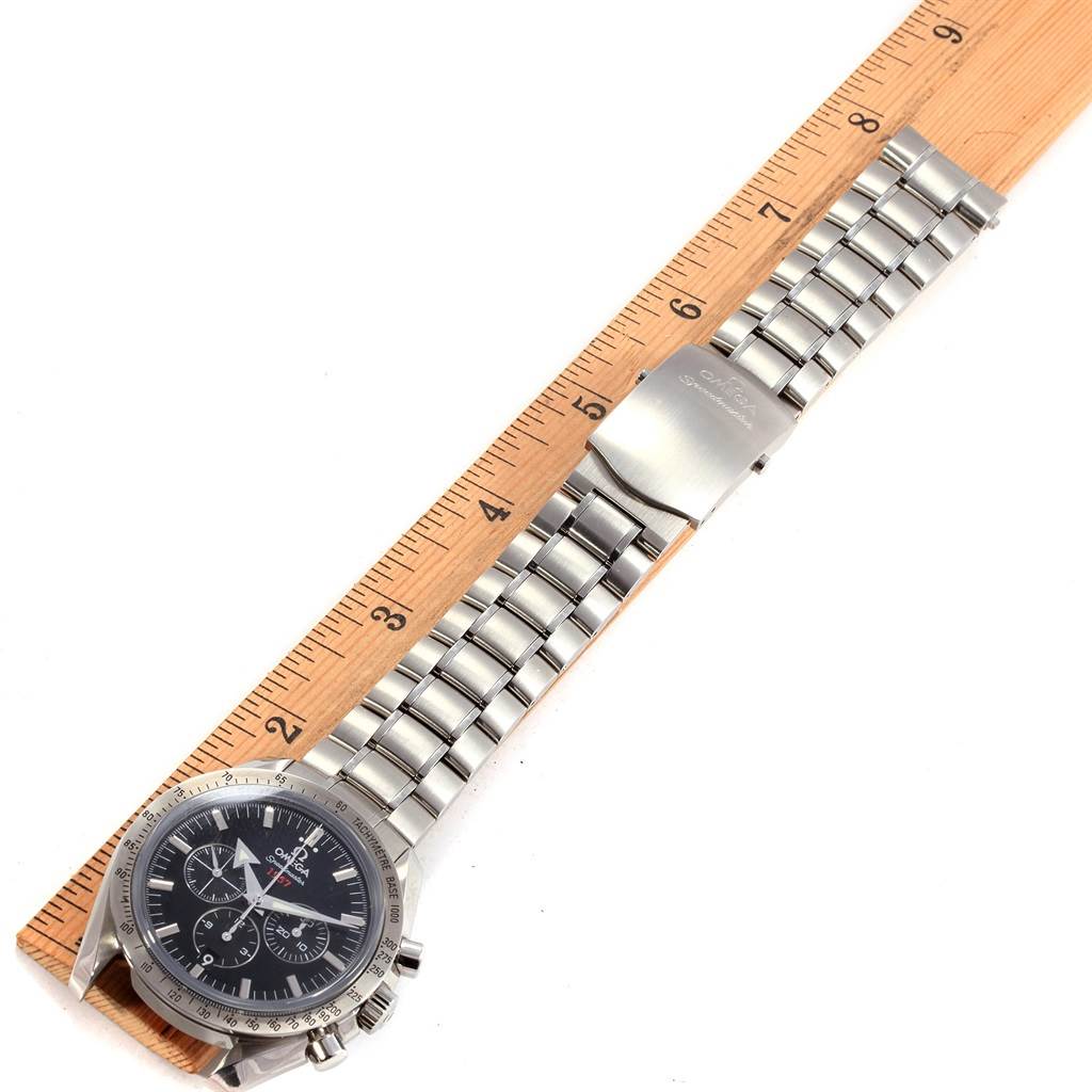 The image shows an Omega Speedmaster 321.10.42.50.01.001 Men
s Stainless Steel Black Dial 321.10.42.50.01.001 Men
s Stainless Steel Black Dial watch laid flat next to a ruler, displaying the dial face, bracelet, and clasp.