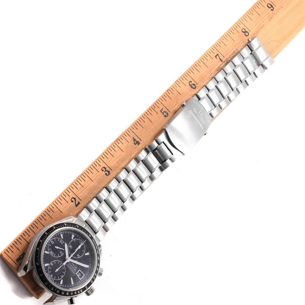 The image shows an Omega Speedmaster 3210.50.00 Men
s Stainless Steel Black Dial 3210.50.00 Men
s Stainless Steel Black Dial watch laid flat next to a ruler, highlighting its face and metal bracelet.