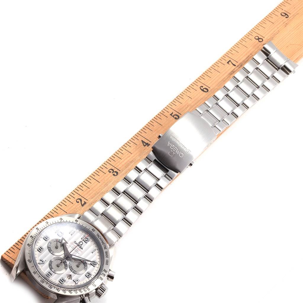 This image shows a top-down view of an Omega Speedmaster 321.10.44.50.02.001 Men
s Stainless Steel Silver Dial 321.10.44.50.02.001 Men
s Stainless Steel Silver Dial watch with its band laid out next to a ruler.