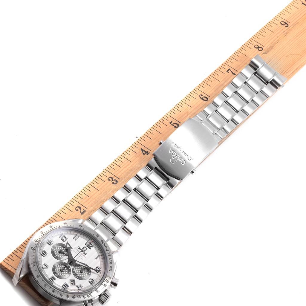 This image shows the Omega Speedmaster 321.10.44.50.02.001 Men
s Stainless Steel Silver Dial 321.10.44.50.02.001 Men
s Stainless Steel Silver Dial watch laid flat with its metal bracelet and clasp, alongside a ruler.
