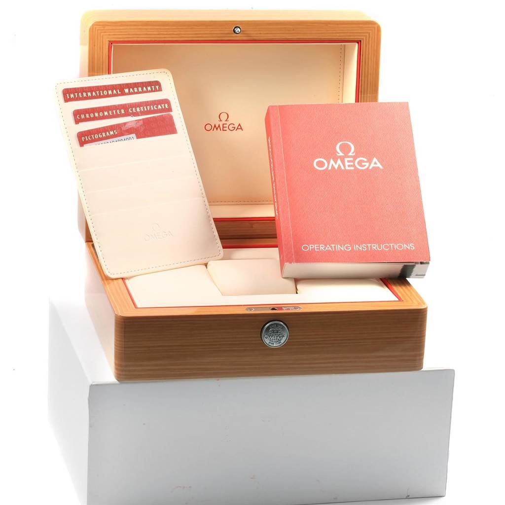 The image shows an Omega Speedmaster 323.30.40.40.04.001 Men's Stainless Steel White Dial 323.30.40.40.04.001 Men's Stainless Steel White Dial model watch box, with warranty card, certificate, and operating instructions visible.