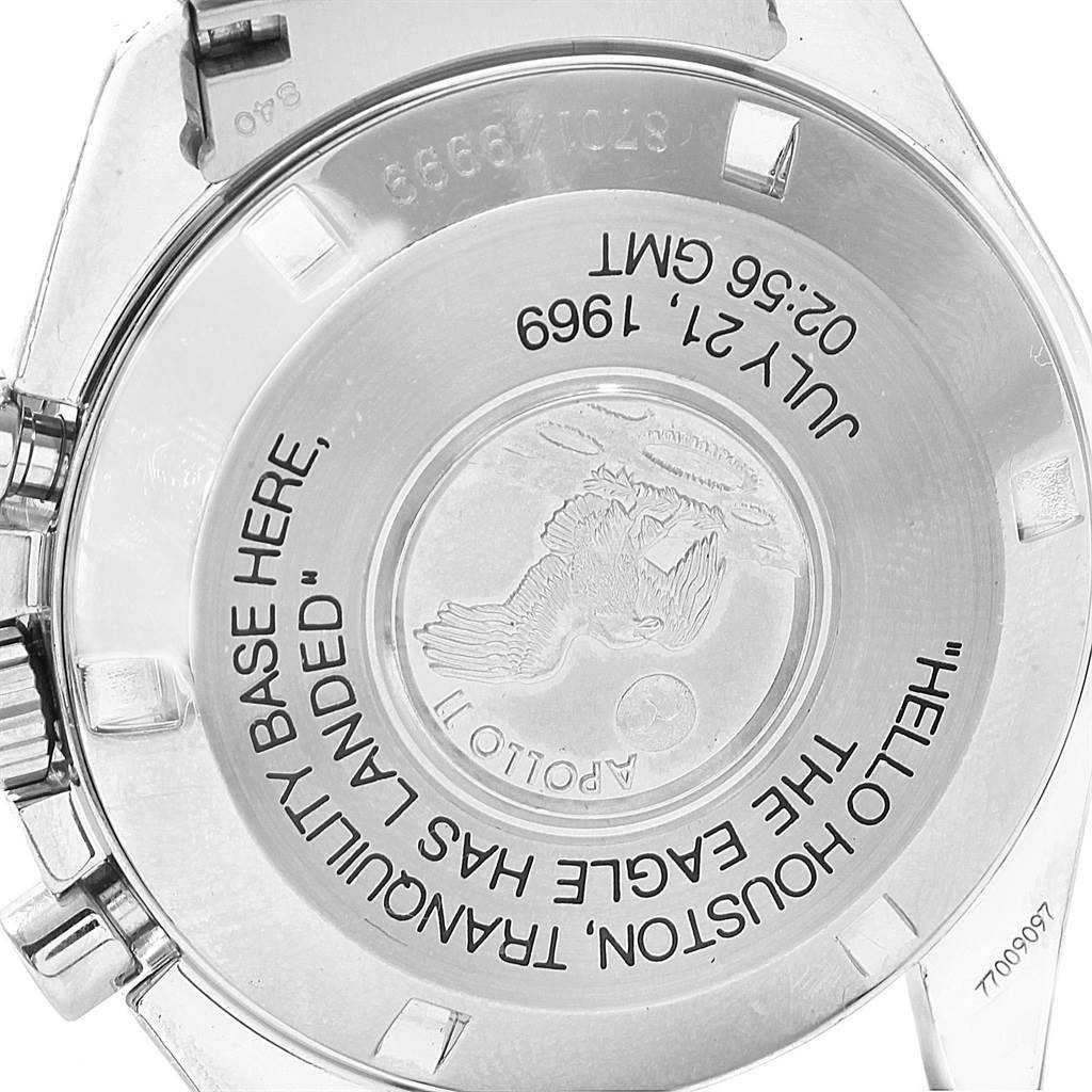 The image shows the case back of the Omega Speedmaster 3560.50.00 Men
s Stainless Steel Black Dial 3560.50.00 Men
s Stainless Steel Black Dial watch with engraved text and an Apollo 11 mission insignia.