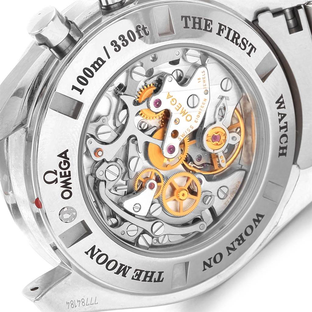 The image shows the back view of the Omega Speedmaster 311.30.44.32.01.001 Men
s Stainless Steel Black Dial 311.30.44.32.01.001 Men
s Stainless Steel Black Dial watch, highlighting its intricate mechanical movement and inscriptions.