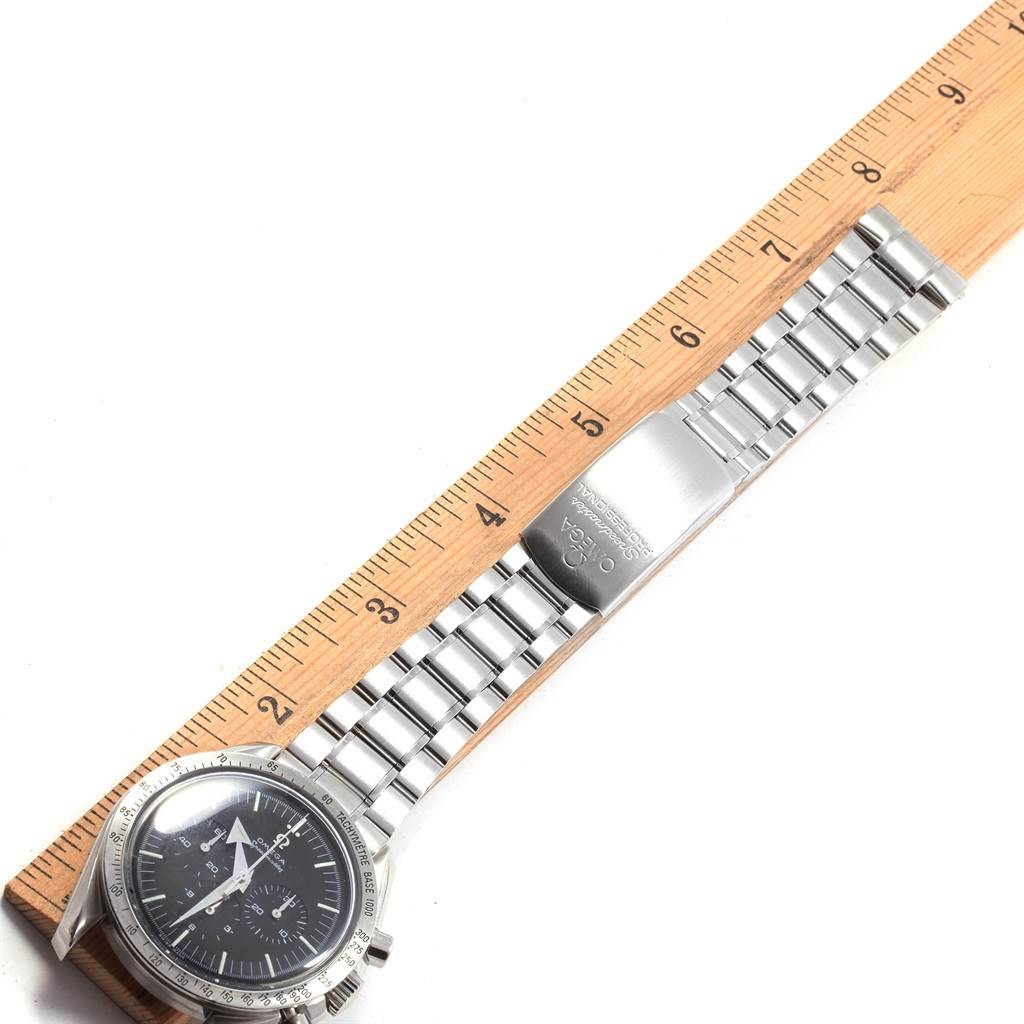 The image shows an Omega Speedmaster 3594.50.00 Men
s Stainless Steel Black Dial 3594.50.00 Men
s Stainless Steel Black Dial watch horizontally aligned with a ruler, displaying the face, bezel, and metal bracelet clasp.