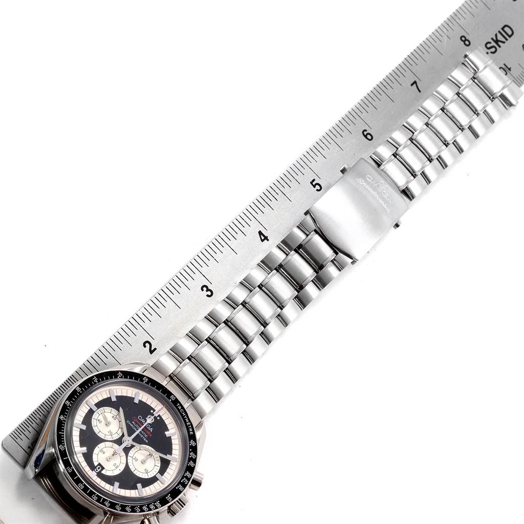 This image shows a top-down view of an Omega Speedmaster 3507.51.00 Men's Stainless Steel Black Dial 3507.51.00 Men's Stainless Steel Black Dial watch with a stainless steel bracelet beside a ruler.