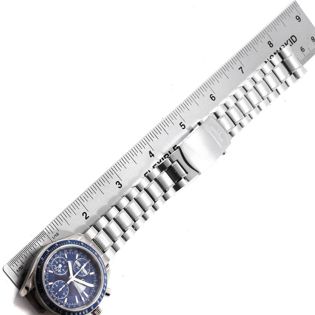The image shows the Omega Speedmaster 3222.80.00 Men
s Stainless Steel Blue Dial 3222.80.00 Men
s Stainless Steel Blue Dial watch at an angle alongside a ruler, highlighting the face, bracelet, and clasp.