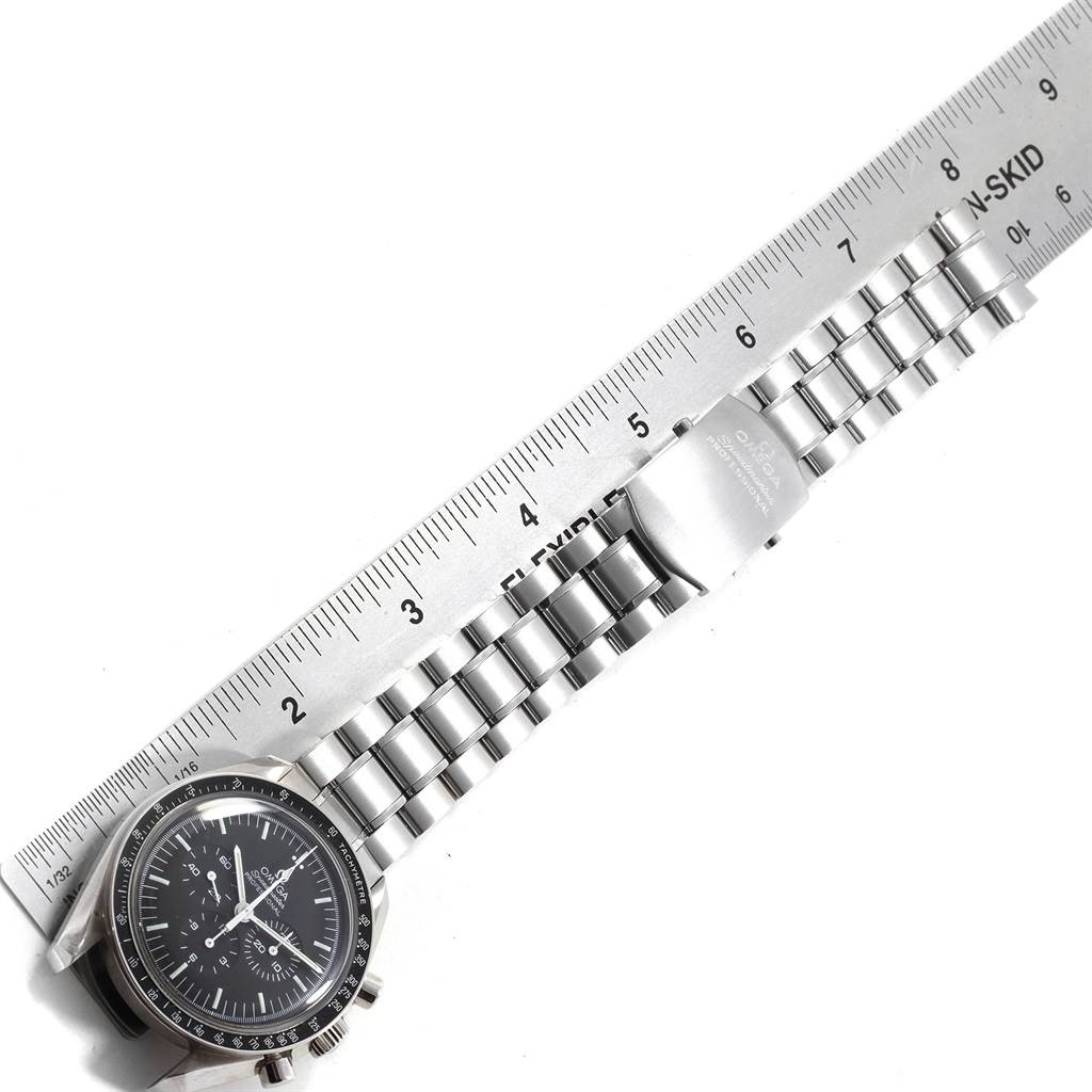 The image shows the Omega Speedmaster 311.30.42.30.01.005 Men
s Stainless Steel Black Dial 311.30.42.30.01.005 Men
s Stainless Steel Black Dial watch laid flat with a ruler, displaying its face and metal bracelet.