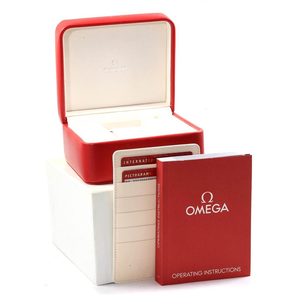 This image shows an Omega Speedmaster 321.10.44.50.02.001 Men
s Stainless Steel Silver Dial 321.10.44.50.02.001 Men
s Stainless Steel Silver Dial watch box with cards and an instruction booklet from a side angle.