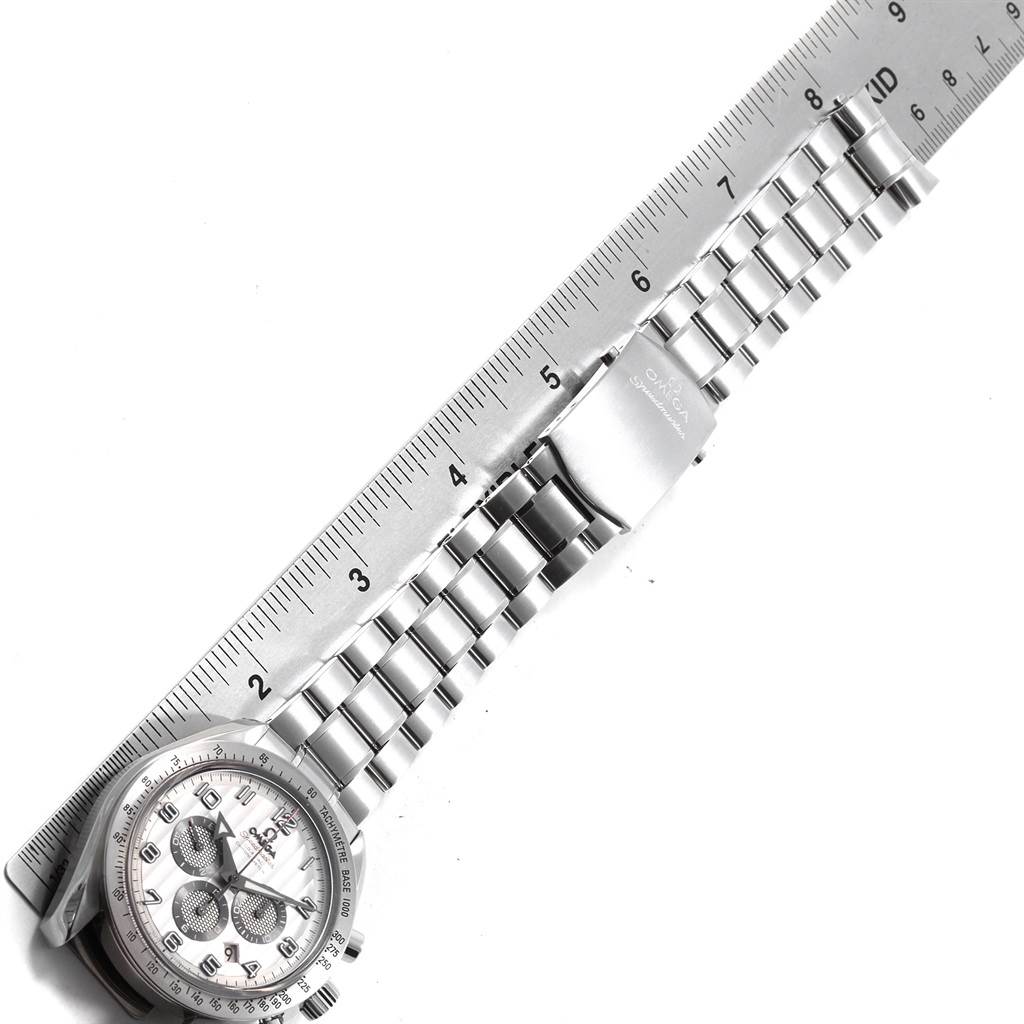 The Omega Speedmaster 321.10.44.50.02.001 Men
s Stainless Steel Silver Dial 321.10.44.50.02.001 Men
s Stainless Steel Silver Dial watch is shown from a top-down angle, highlighting the watch face and metal bracelet beside a ruler.