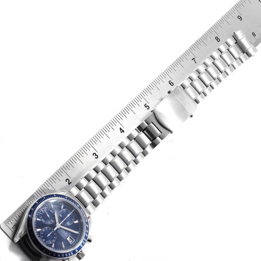 The image shows the Omega Speedmaster 3212.80.00 Men
s Stainless Steel Blue Dial 3212.80.00 Men
s Stainless Steel Blue Dial watch face and stainless steel bracelet, measured against a ruler.