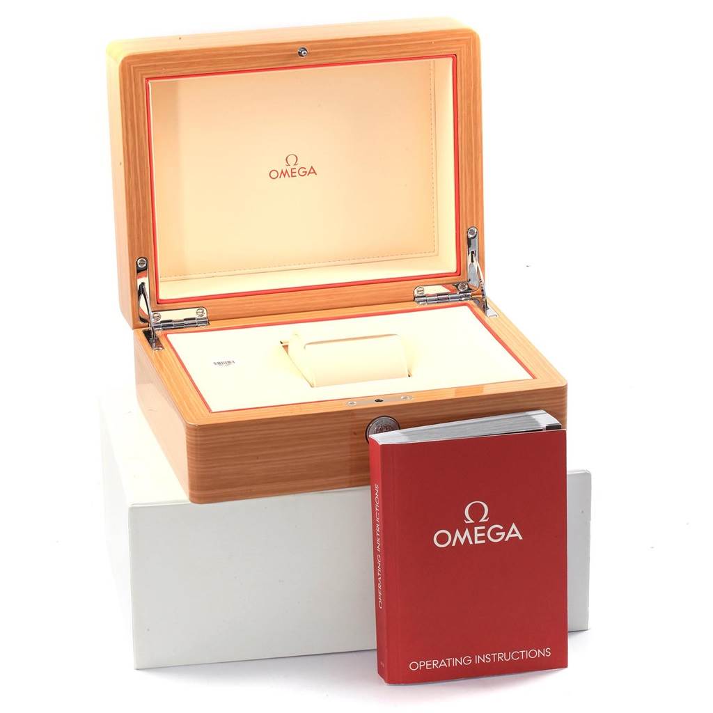 The image shows an Omega Speedmaster 326.30.40.50.01.001 Men
s Stainless Steel Black Dial 326.30.40.50.01.001 Men
s Stainless Steel Black Dial watch box and its operating instructions booklet; the box is open, displaying the interior.