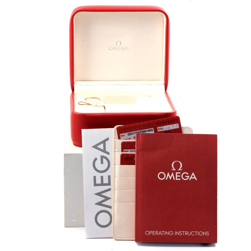 The image shows the accessories for the Omega Speedmaster 311.30.42.30.01.002 Men's Stainless Steel Black Dial 311.30.42.30.01.002 Men's Stainless Steel Black Dial, including the box, operating instructions, warranty cards, and cardholder.