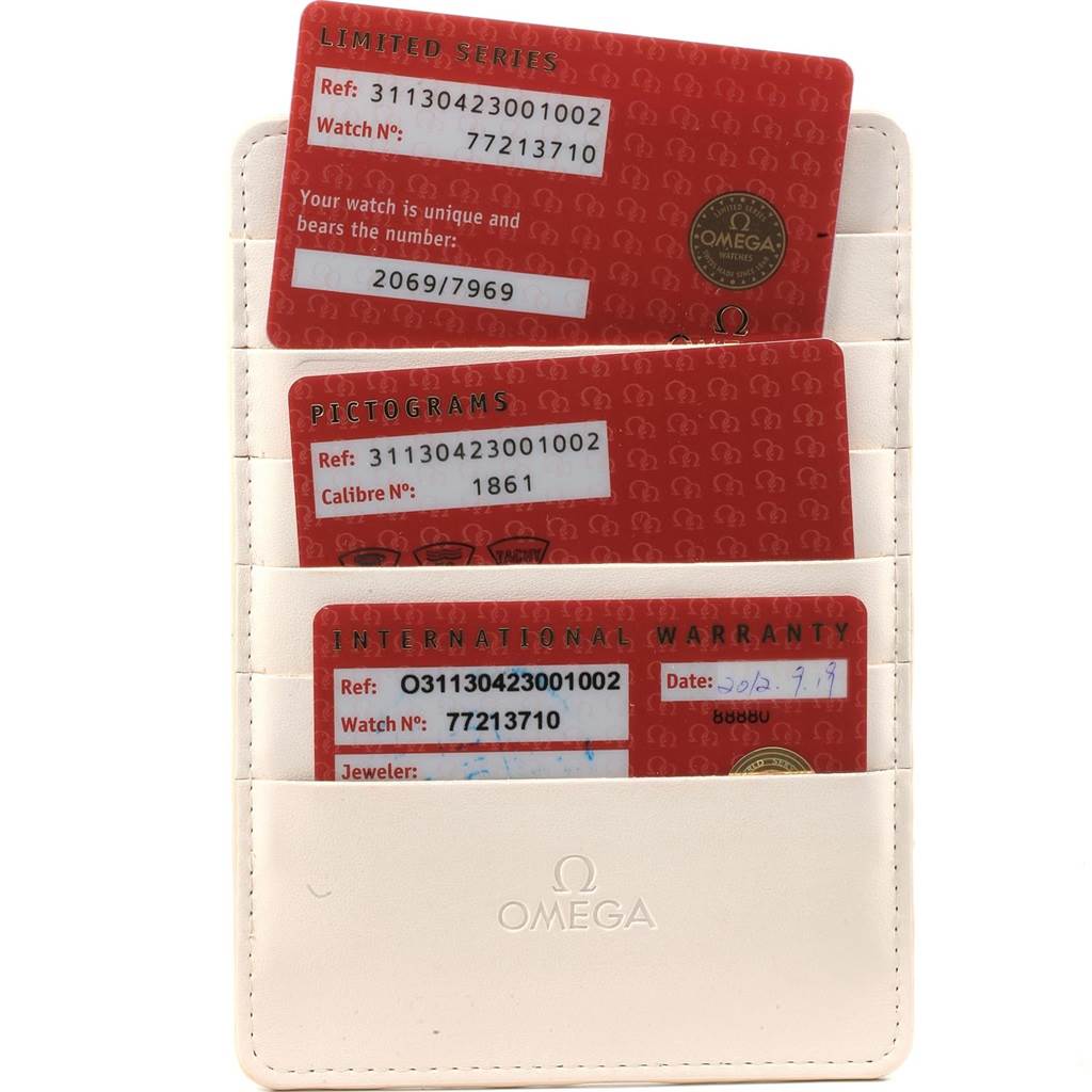 The image shows Omega Speedmaster 311.30.42.30.01.002 Men's Stainless Steel Black Dial 311.30.42.30.01.002 Men's Stainless Steel Black Dial model warranty cards in a leather holder.