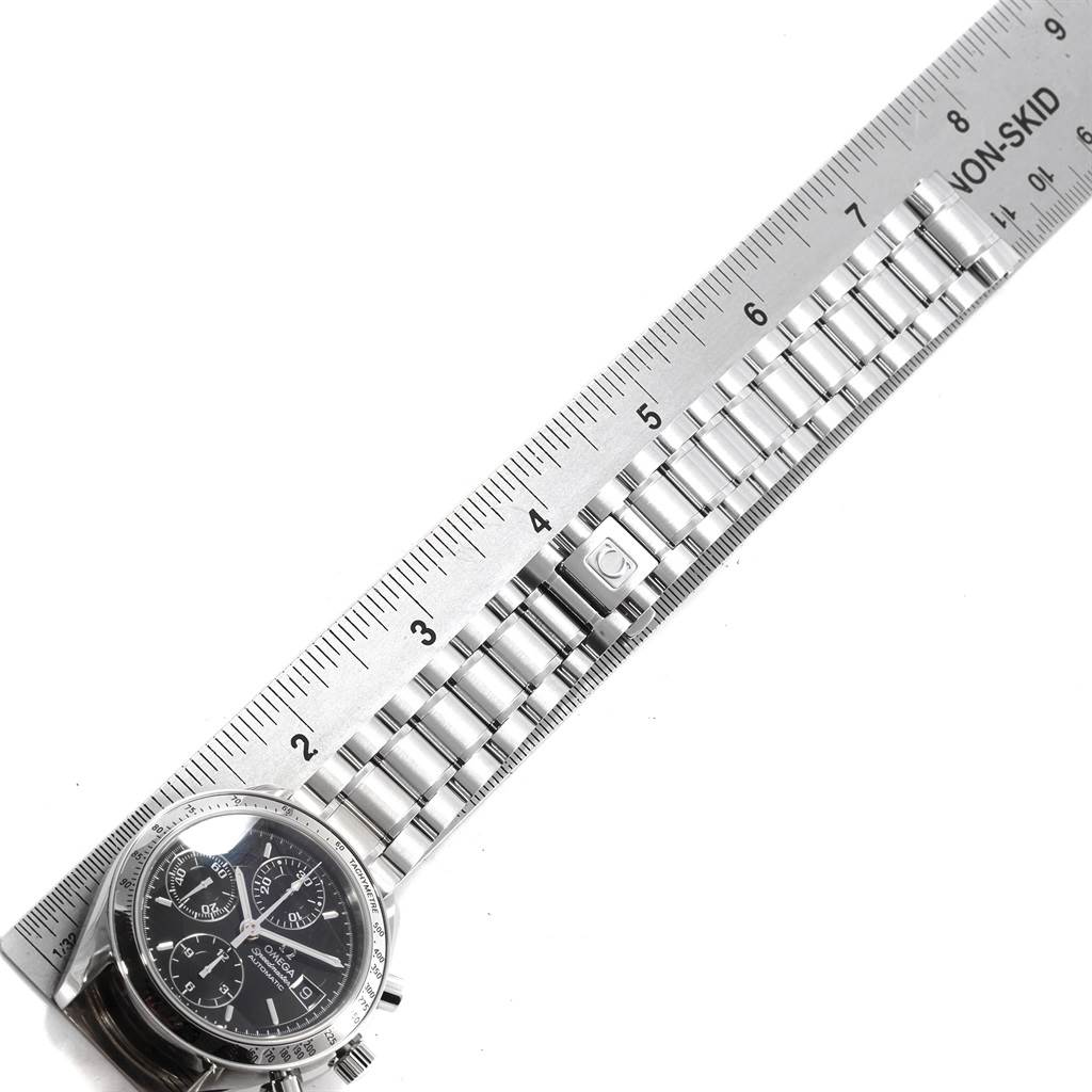The image shows the Omega Speedmaster 3513.50.00 Men
s Stainless Steel Black Dial 3513.50.00 Men
s Stainless Steel Black Dial watch face and a ruler measuring its metal bracelet.
