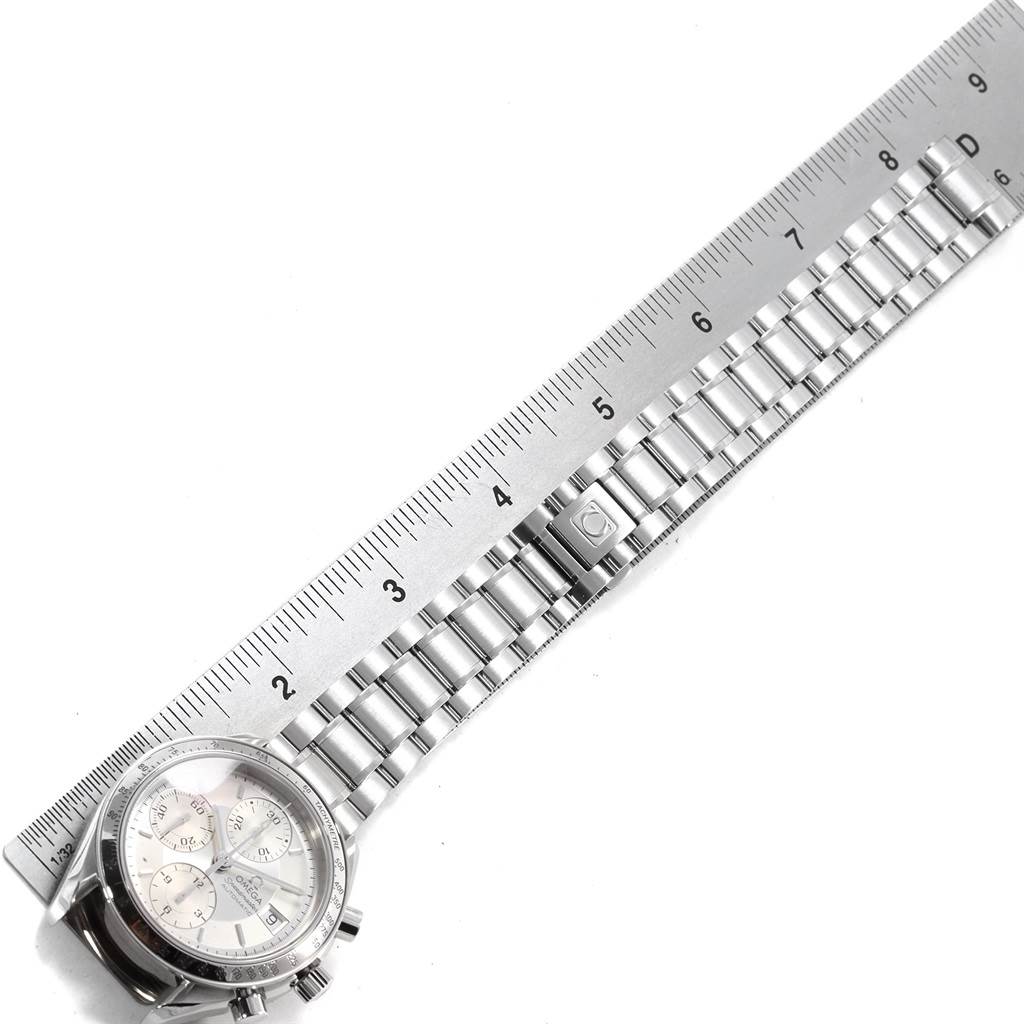 The Omega Speedmaster 3513.30.00 Men
s Stainless Steel Silver Dial 3513.30.00 Men
s Stainless Steel Silver Dial watch is shown from a top-down angle with its bracelet extended alongside a ruler.