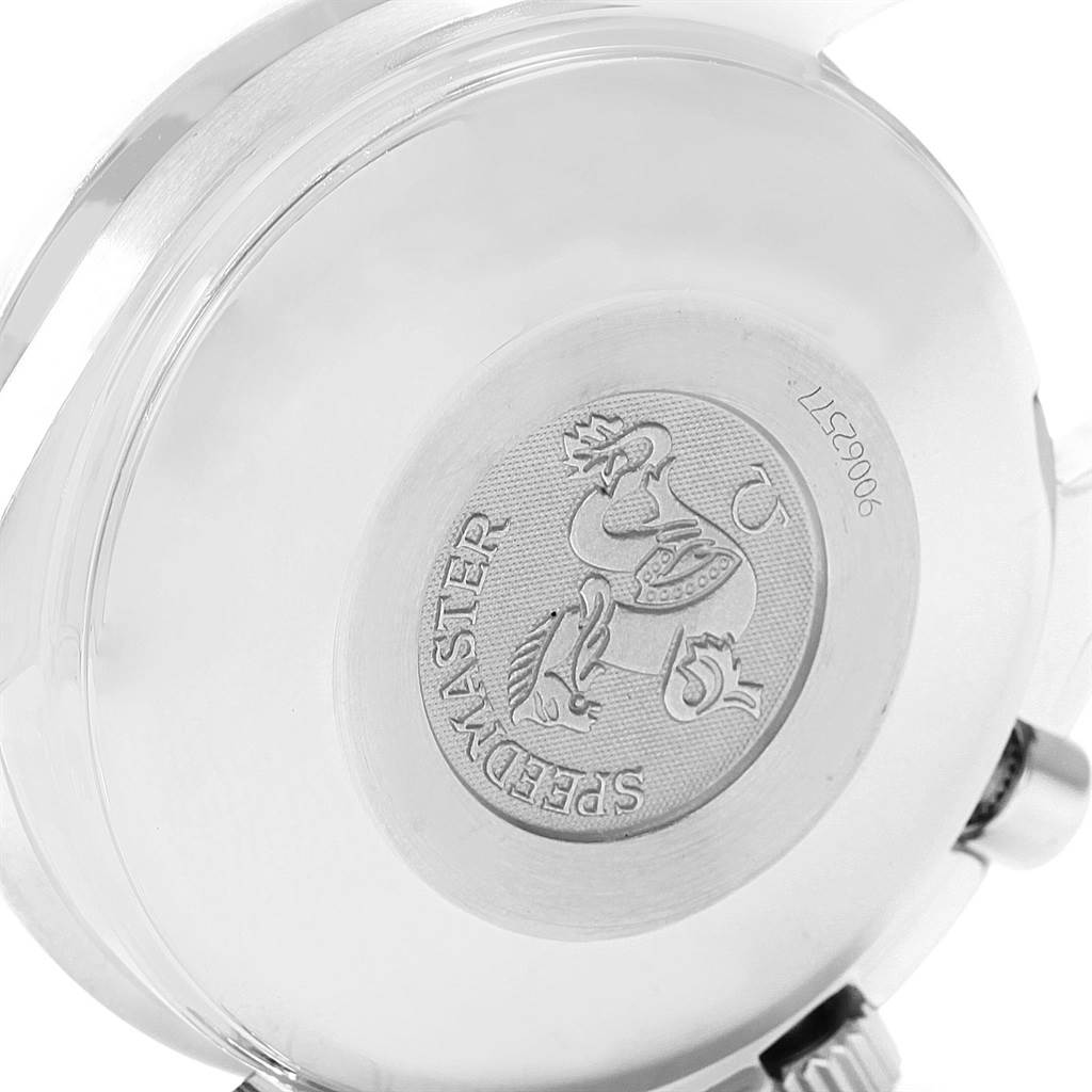 A close-up of the Speedmaster by Omega, showing the back case and engraved emblem, partially including the crown and pushers.