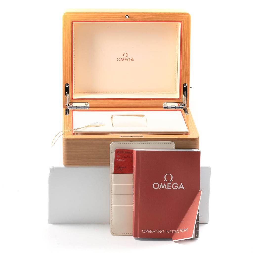 The image shows the storage box and manuals for the Omega Speedmaster 326.30.40.50.02.001 Men
s Stainless Steel Silver Dial 326.30.40.50.02.001 Men
s Stainless Steel Silver Dial watch from a front angle.