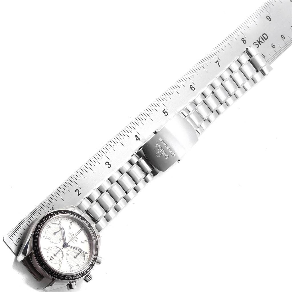 The Omega Speedmaster 326.30.40.50.02.001 Men
s Stainless Steel Silver Dial 326.30.40.50.02.001 Men
s Stainless Steel Silver Dial watch is shown from a top-down angle, featuring the full watchband and partially visible face, alongside a ruler for scale.