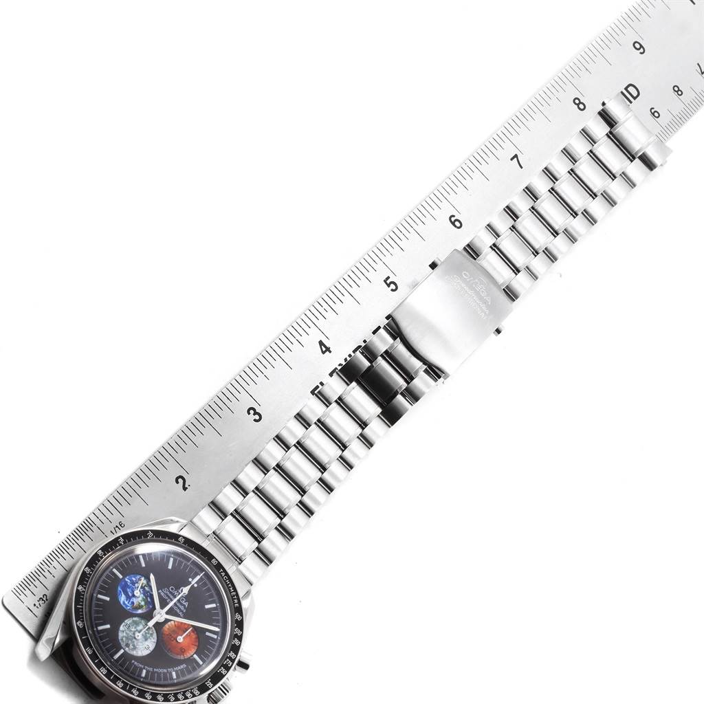 The Omega Speedmaster 3577.50.00 Men's Stainless Steel Black Dial 3577.50.00 Men's Stainless Steel Black Dial watch is shown from a top-down angle, featuring the face and full stainless steel bracelet laid alongside a ruler.