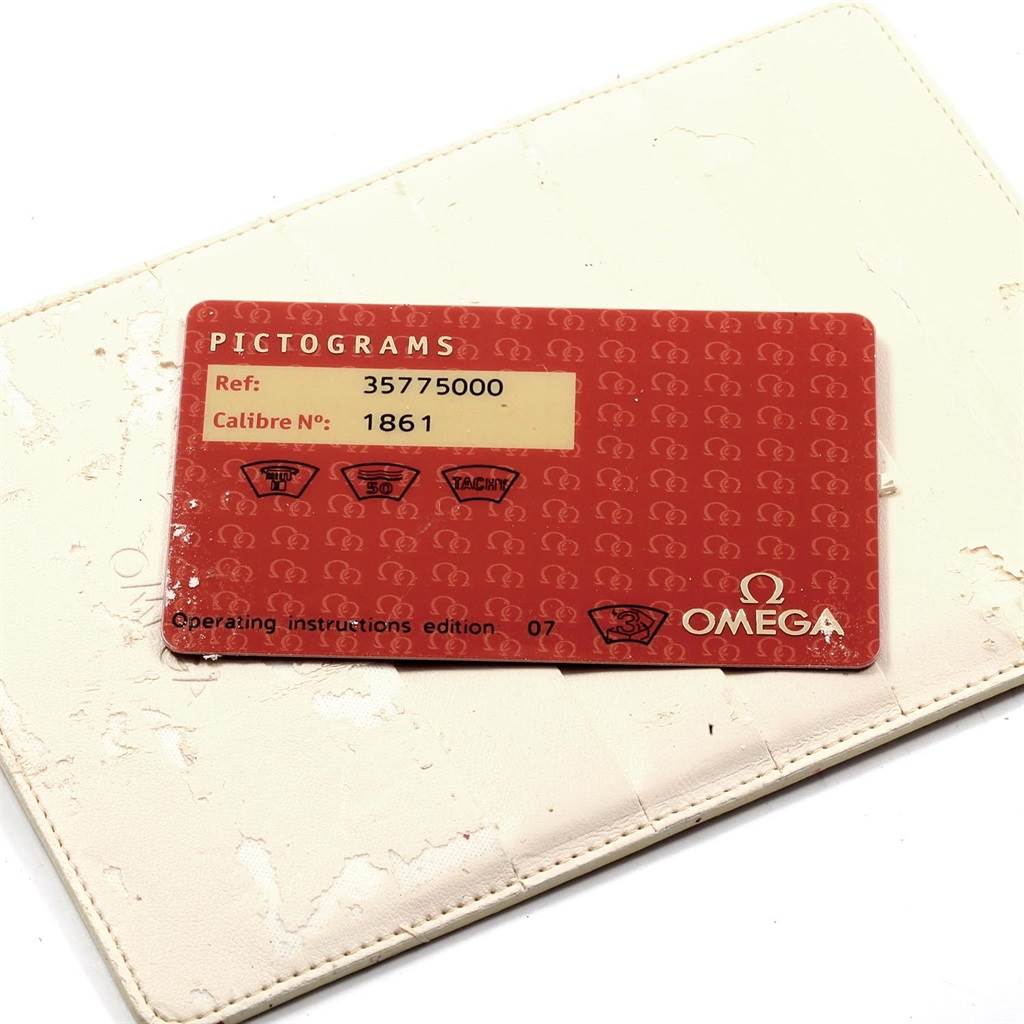 This image shows the warranty and pictogram card for an Omega Speedmaster 3577.50.00 Men's Stainless Steel Black Dial 3577.50.00 Men's Stainless Steel Black Dial watch, placed on a white surface.