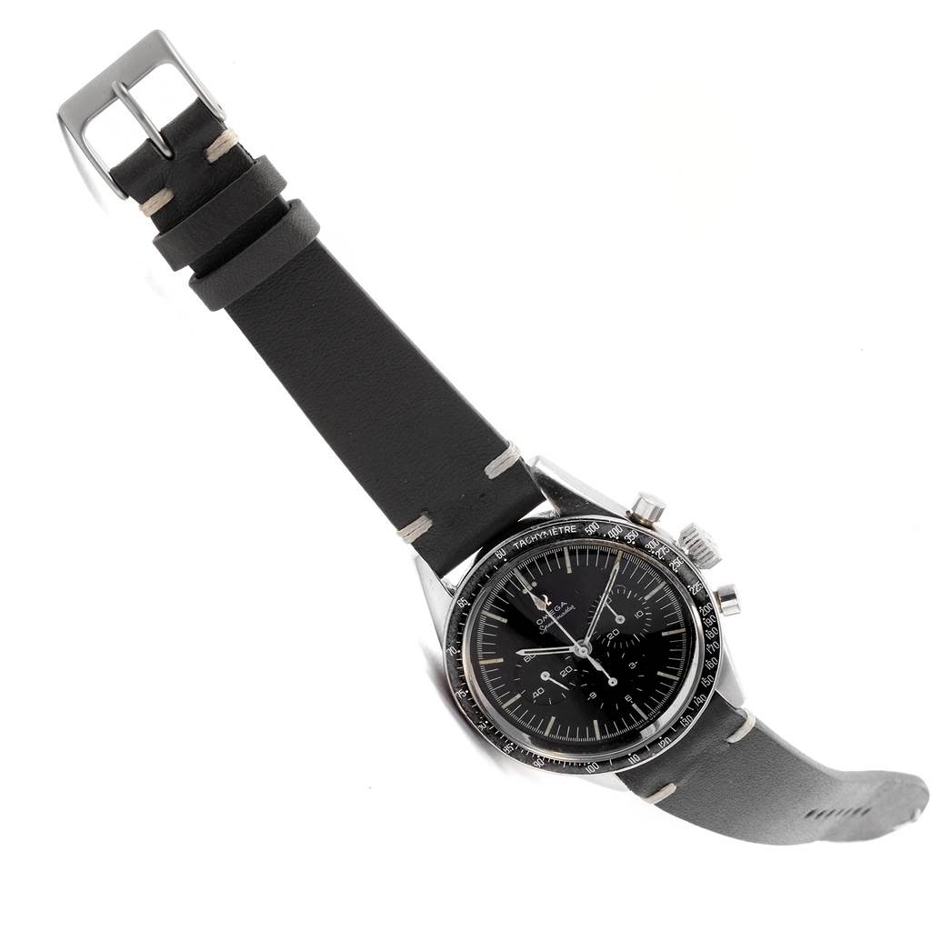 This image shows the Omega Speedmaster 105.003-64 Men
s Stainless Steel Black Dial 105.003-64 Men
s Stainless Steel Black Dial watch at a diagonal angle, highlighting its dial, bezel, and leather strap.