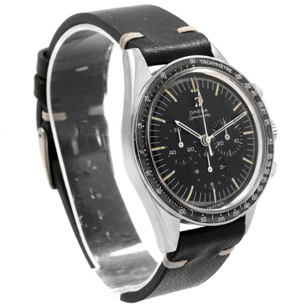 The image shows an angled view of an Omega Speedmaster 105.003-64 Men
s Stainless Steel Black Dial 105.003-64 Men
s Stainless Steel Black Dial watch, highlighting the face, tachymeter bezel, and leather strap.