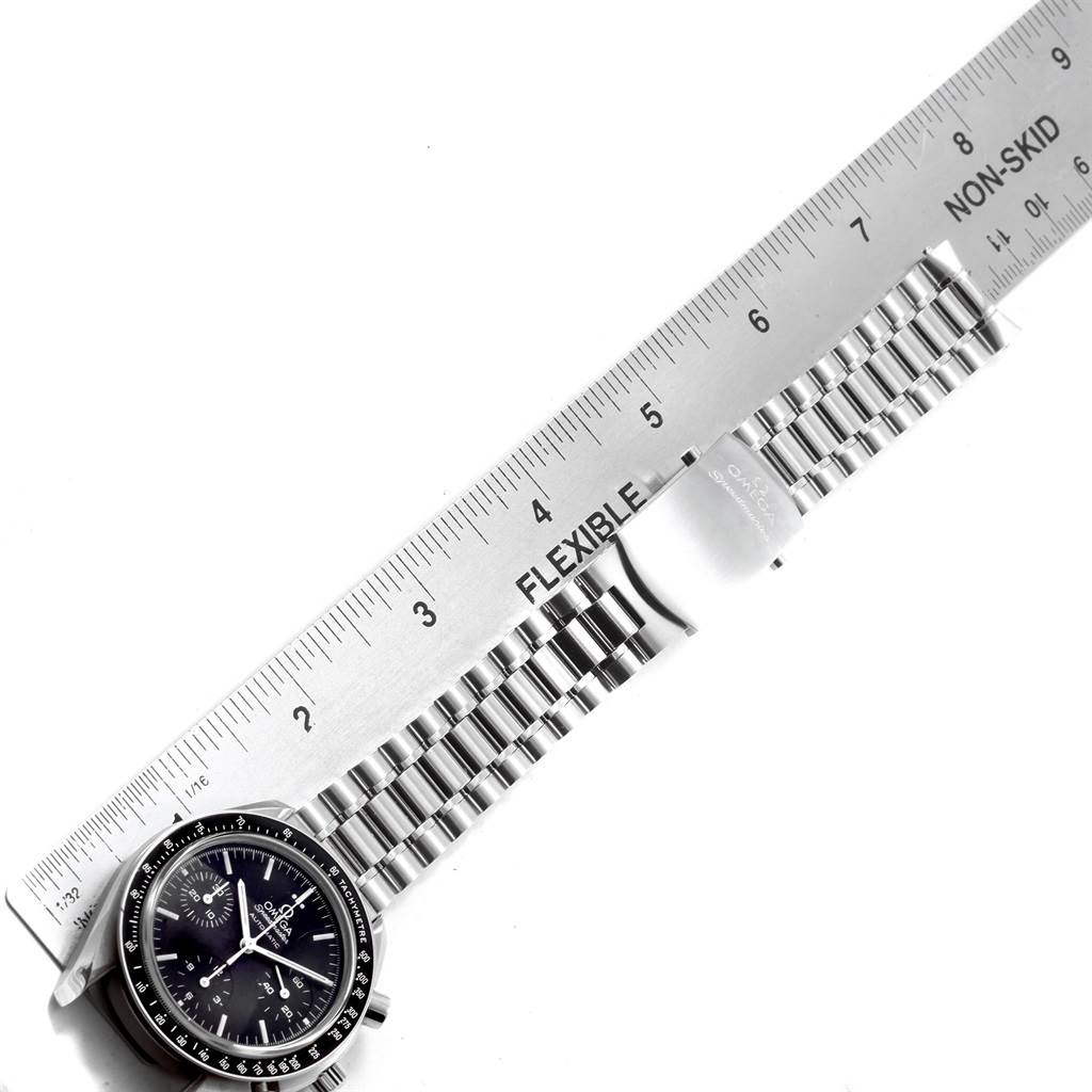 The image shows an Omega Speedmaster 3539.50.00 Men
s Stainless Steel Black Dial 3539.50.00 Men
s Stainless Steel Black Dial watch with focus on the face, bezel, and bracelet, alongside a flexible ruler for size reference.