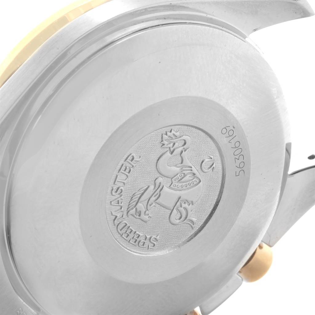 The image shows the case back of an Omega Speedmaster 3313.33.00 Men's Steel and Gold (two tone) White Dial 3313.33.00 Men's Steel and Gold (two tone) White Dial watch, featuring its engraved emblem and serial number.