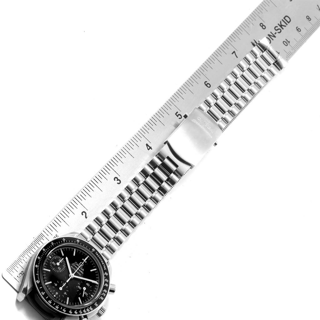 The image shows an angled view of the Omega Speedmaster 3539.50.00 Men
s Stainless Steel Black Dial 3539.50.00 Men
s Stainless Steel Black Dial watch with its metallic band measured against a ruler.