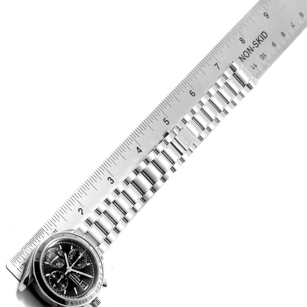 The image shows the Omega Speedmaster 3513.50.00 Men
s Stainless Steel Black Dial 3513.50.00 Men
s Stainless Steel Black Dial watch face and part of its metal bracelet, aligned next to a ruler for measurement.