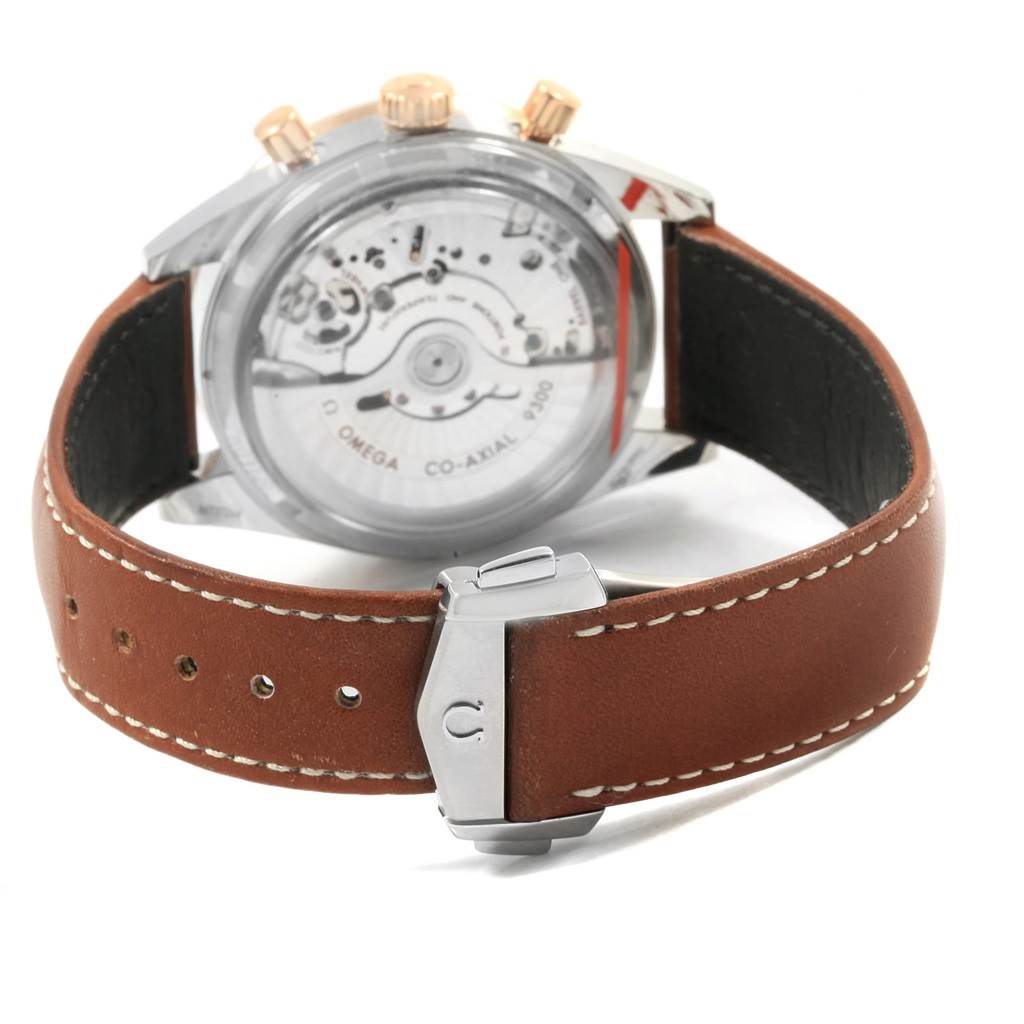 The image shows the back view of an Omega Speedmaster 331.22.42.51.01.001 Men's Steel and Gold (two tone) Black Dial 331.22.42.51.01.001 Men's Steel and Gold (two tone) Black Dial watch, displaying its movement and brown leather strap with a clasp.