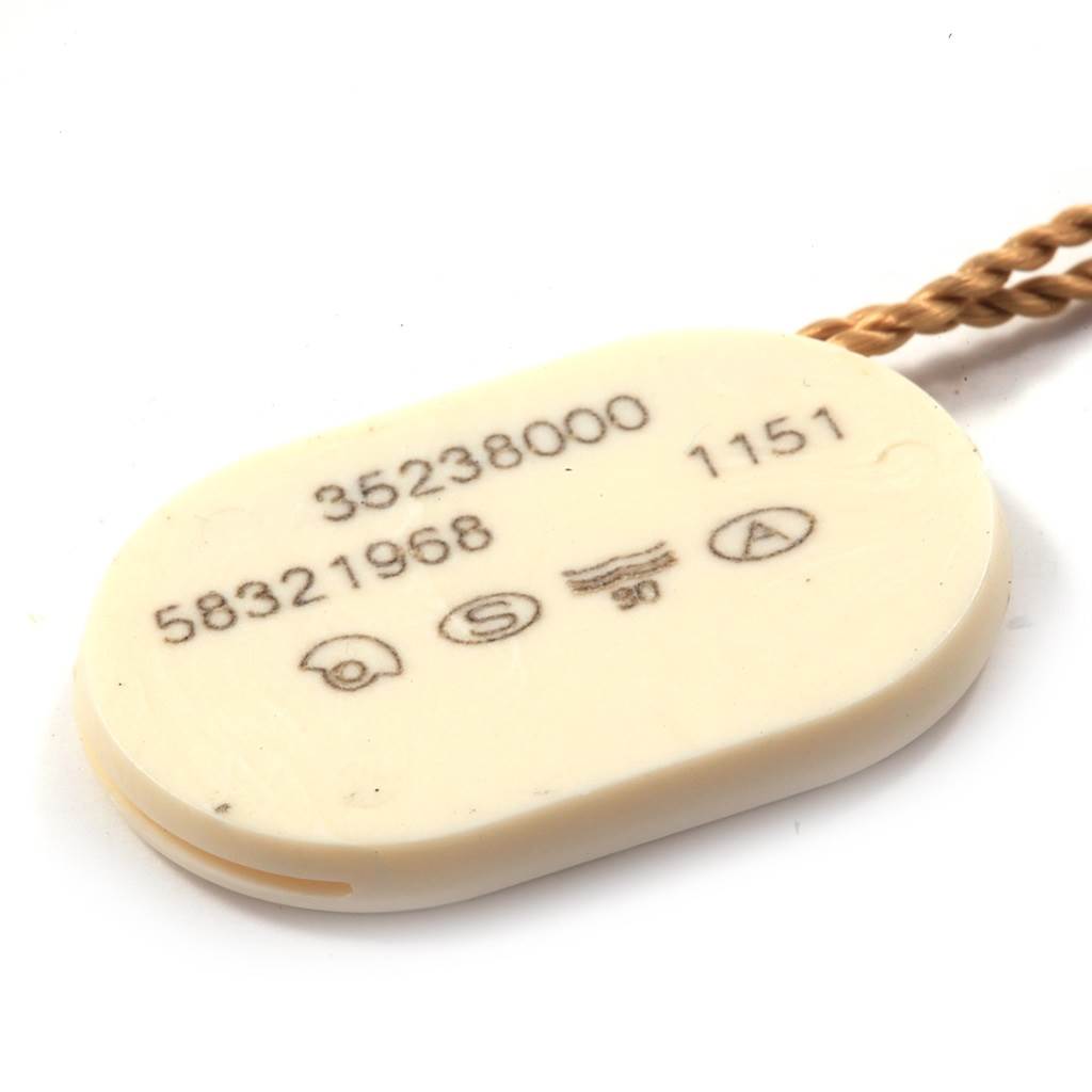 The image shows an Omega Speedmaster 3523.80.00 Men
s Stainless Steel Blue Dial 3523.80.00 Men
s Stainless Steel Blue Dial model accessory tag with serial numbers, viewed from the top.