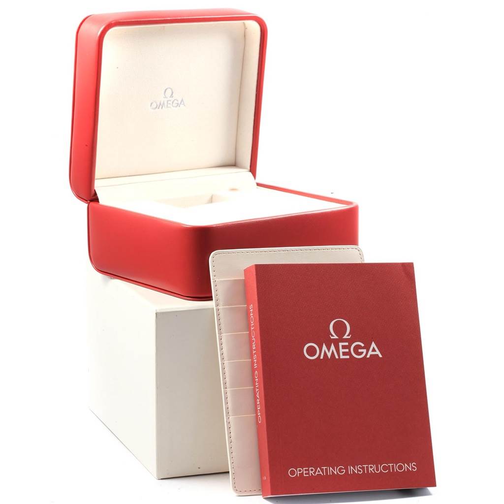 This image shows an Omega Speedmaster 323.21.40.40.01.001 Men
s Stainless Steel Black Dial 323.21.40.40.01.001 Men
s Stainless Steel Black Dial watch box, operating instructions booklet, and a warranty card holder, viewed from the front.