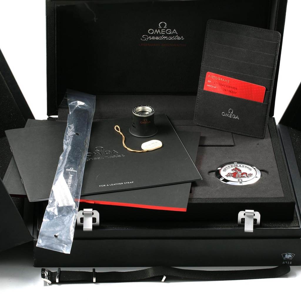 The image shows various accessories for the Omega Speedmaster 311.30.42.30.01.005 Men
s Stainless Steel Black Dial 311.30.42.30.01.005 Men
s Stainless Steel Black Dial watch, including a magnifying glass, case back, manual, and strap tool.