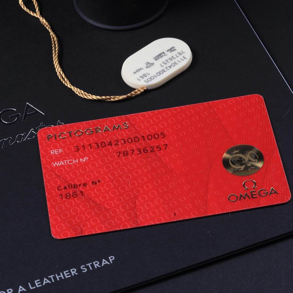 The image shows an Omega Speedmaster 311.30.42.30.01.005 Men
s Stainless Steel Black Dial 311.30.42.30.01.005 Men
s Stainless Steel Black Dial
s pictogram card and a white tag against a branded background.