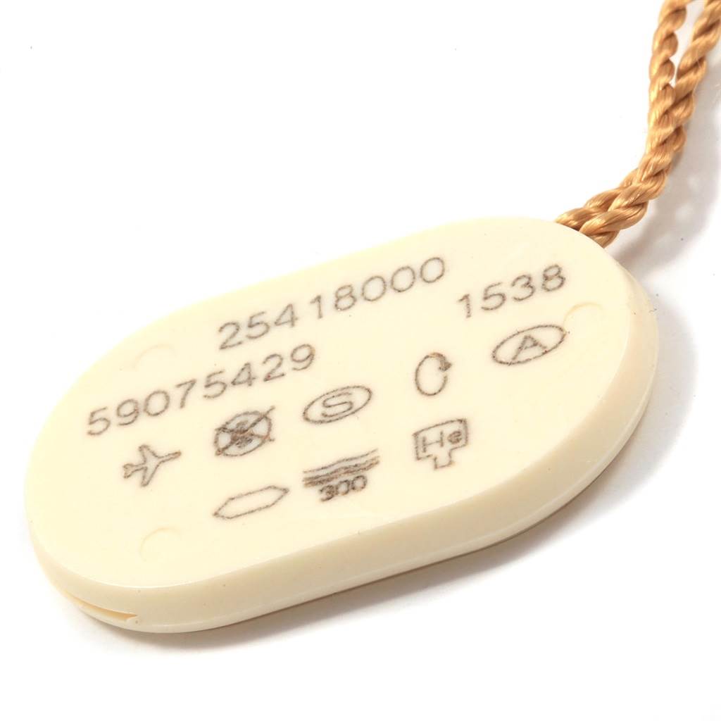 The image shows a close-up of a watch tag with numbers and symbols, attached to the Omega Speedmaster 3212.80.00 Men
s Stainless Steel Blue Dial 3212.80.00 Men
s Stainless Steel Blue Dial model.