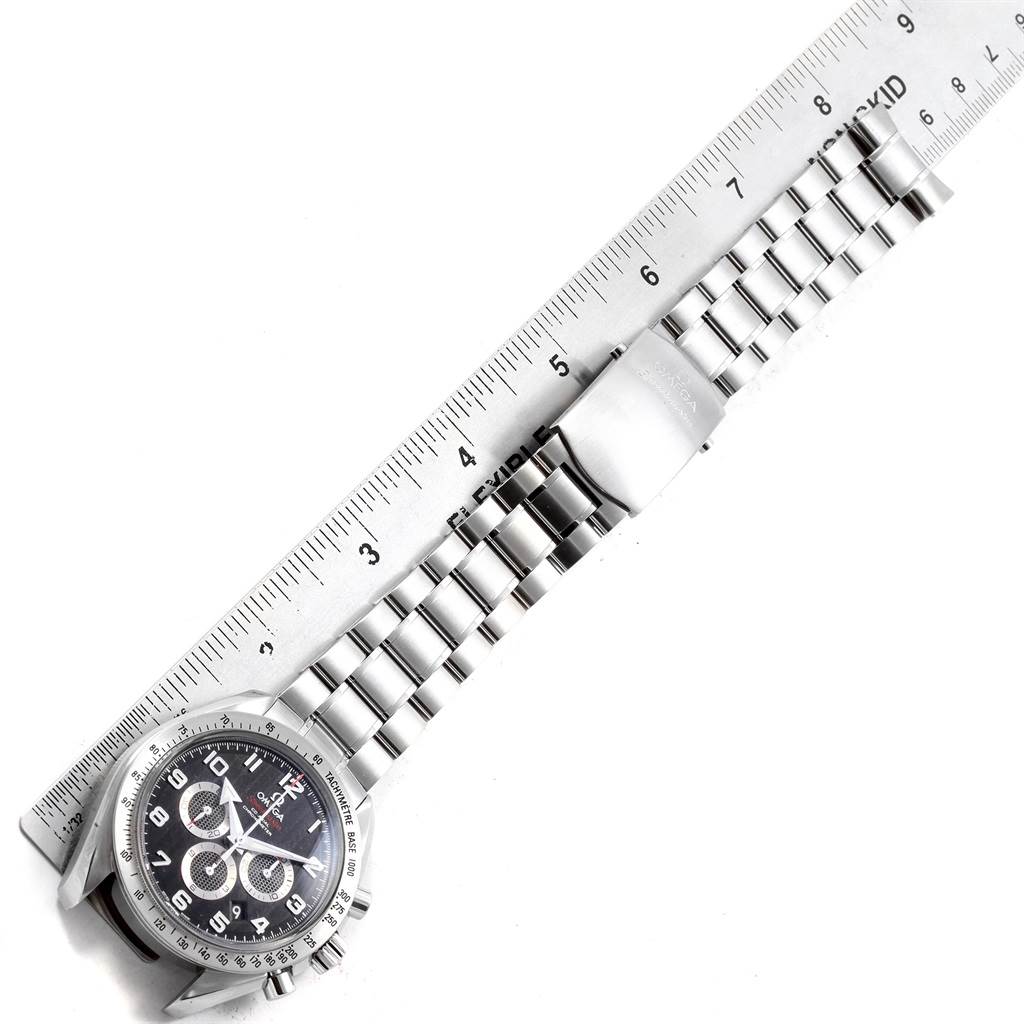 The image shows an Omega Speedmaster 321.10.44.50.01.001 Men
s Stainless Steel Black Dial 321.10.44.50.01.001 Men
s Stainless Steel Black Dial watch laid flat against a ruler, displaying the dial, bracelet, and clasp. 