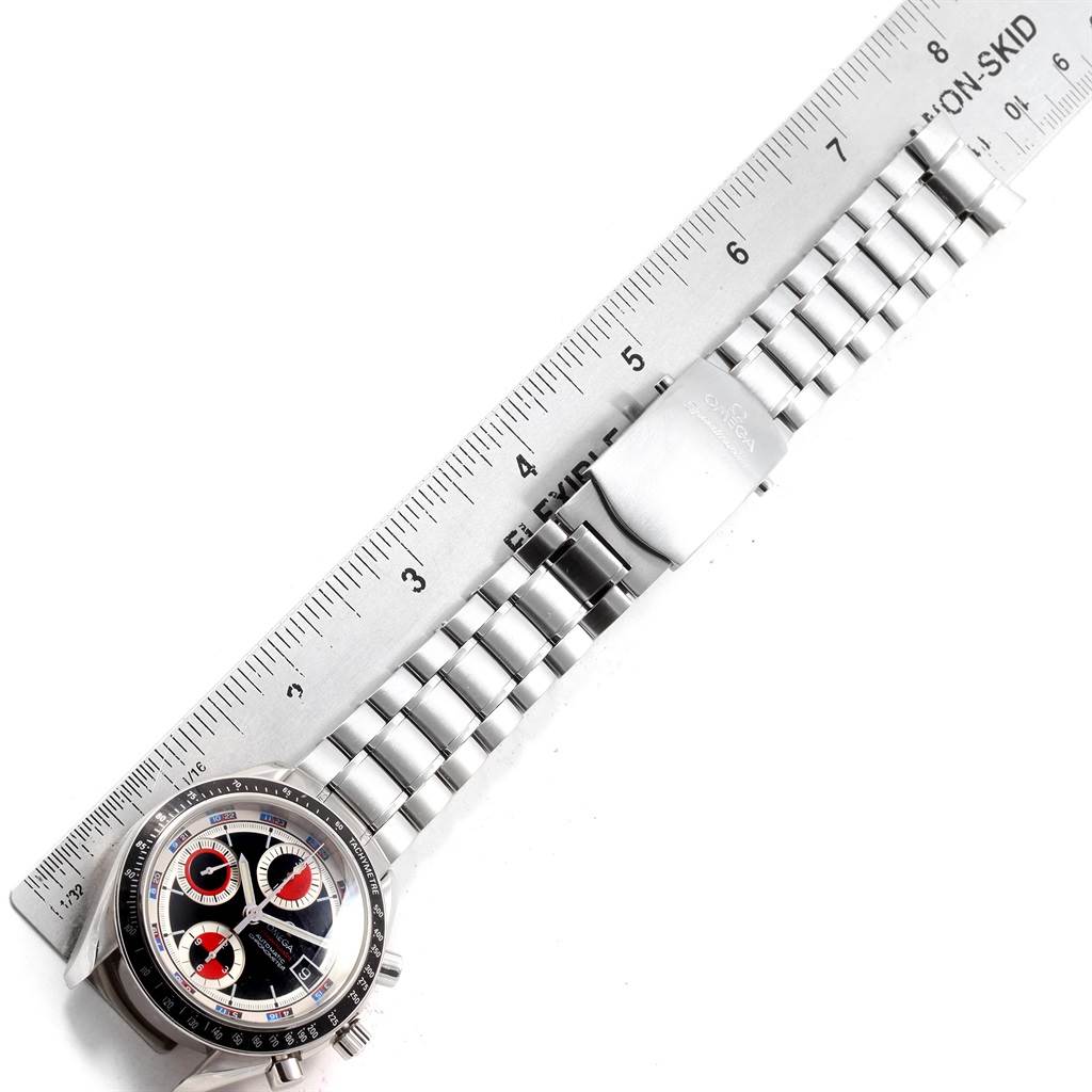 The image shows an overhead view of an Omega Speedmaster 3210.52.00 Men
s Stainless Steel Black Dial 3210.52.00 Men
s Stainless Steel Black Dial watch, highlighting the face, bracelet, and clasp alongside a ruler.