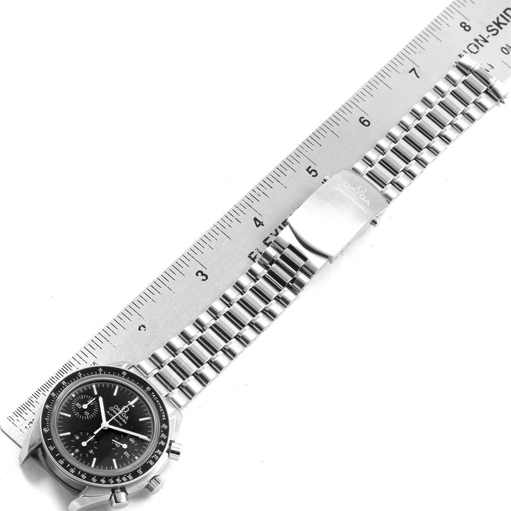 The image shows the face and entire metal bracelet of an Omega Speedmaster 3539.50.00 Men
s Stainless Steel Black Dial 3539.50.00 Men
s Stainless Steel Black Dial, lying next to a ruler for measurement.