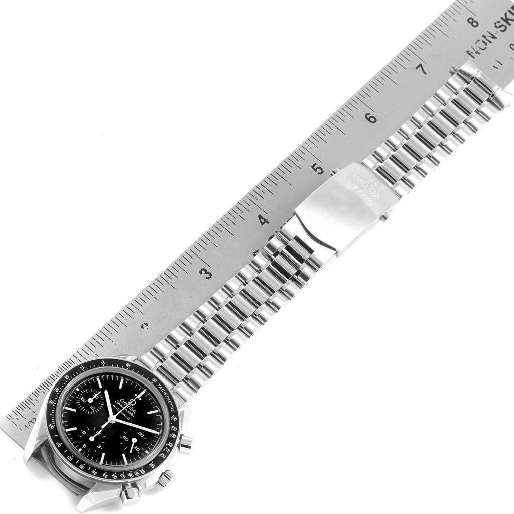 The image shows the Omega Speedmaster 3539.50.00 Men
s Stainless Steel Black Dial 3539.50.00 Men
s Stainless Steel Black Dial watch laid flat next to a ruler, displaying its face, strap, and clasp.
