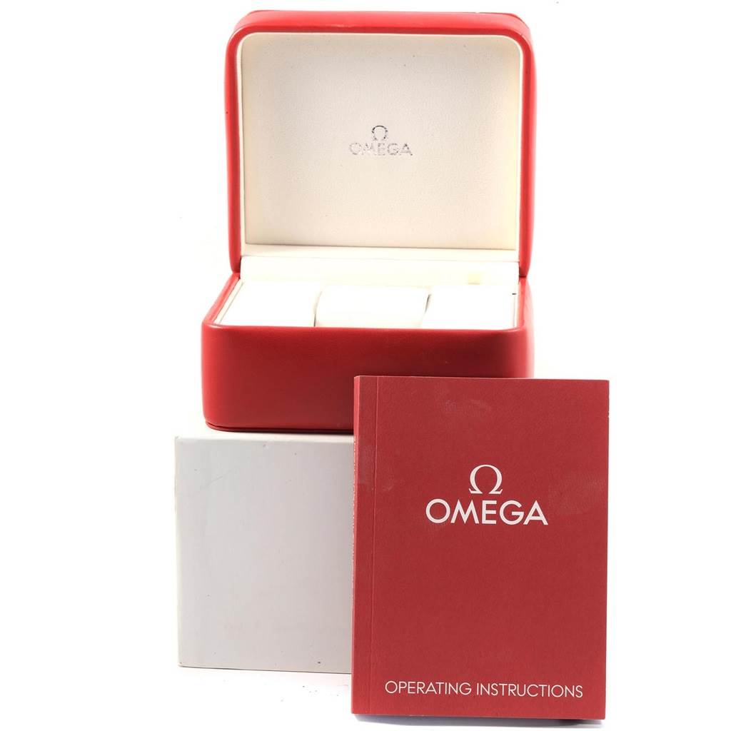 The image shows an open Omega Speedmaster 321.10.44.50.02.001 Men
s Stainless Steel Silver Dial 321.10.44.50.02.001 Men
s Stainless Steel Silver Dial watch box and its red operating instructions booklet from a frontal angle.
