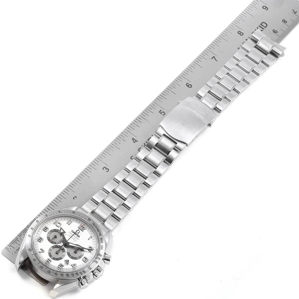 The Omega Speedmaster 321.10.44.50.02.001 Men
s Stainless Steel Silver Dial 321.10.44.50.02.001 Men
s Stainless Steel Silver Dial watch is shown from the top, featuring its face, bezel, and metal bracelet alongside a ruler for scale.