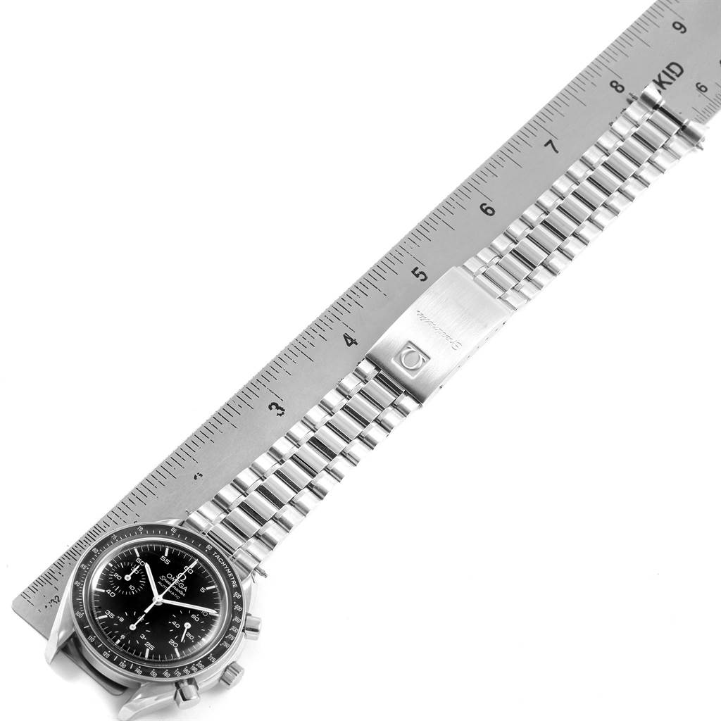 This image shows the Omega Speedmaster 3510.50.00 Men
s Stainless Steel Black Dial 3510.50.00 Men
s Stainless Steel Black Dial watch laid out flat with a metal bracelet and a ruler for scale.