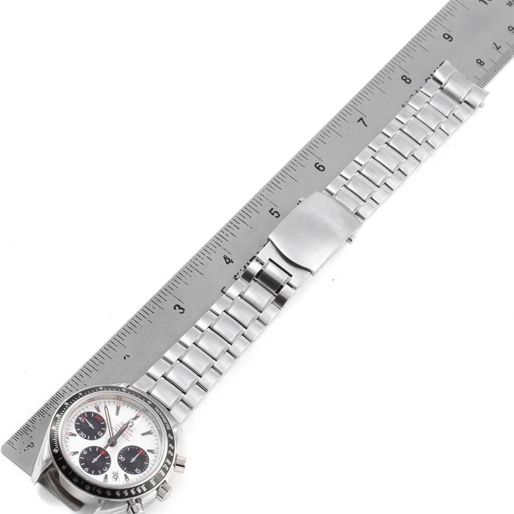 This image shows the Omega Speedmaster 323.30.40.40.04.001 Men
s Stainless Steel White Dial 323.30.40.40.04.001 Men
s Stainless Steel White Dial watch from a top view, displaying the face and full length of the metal bracelet next to a ruler.