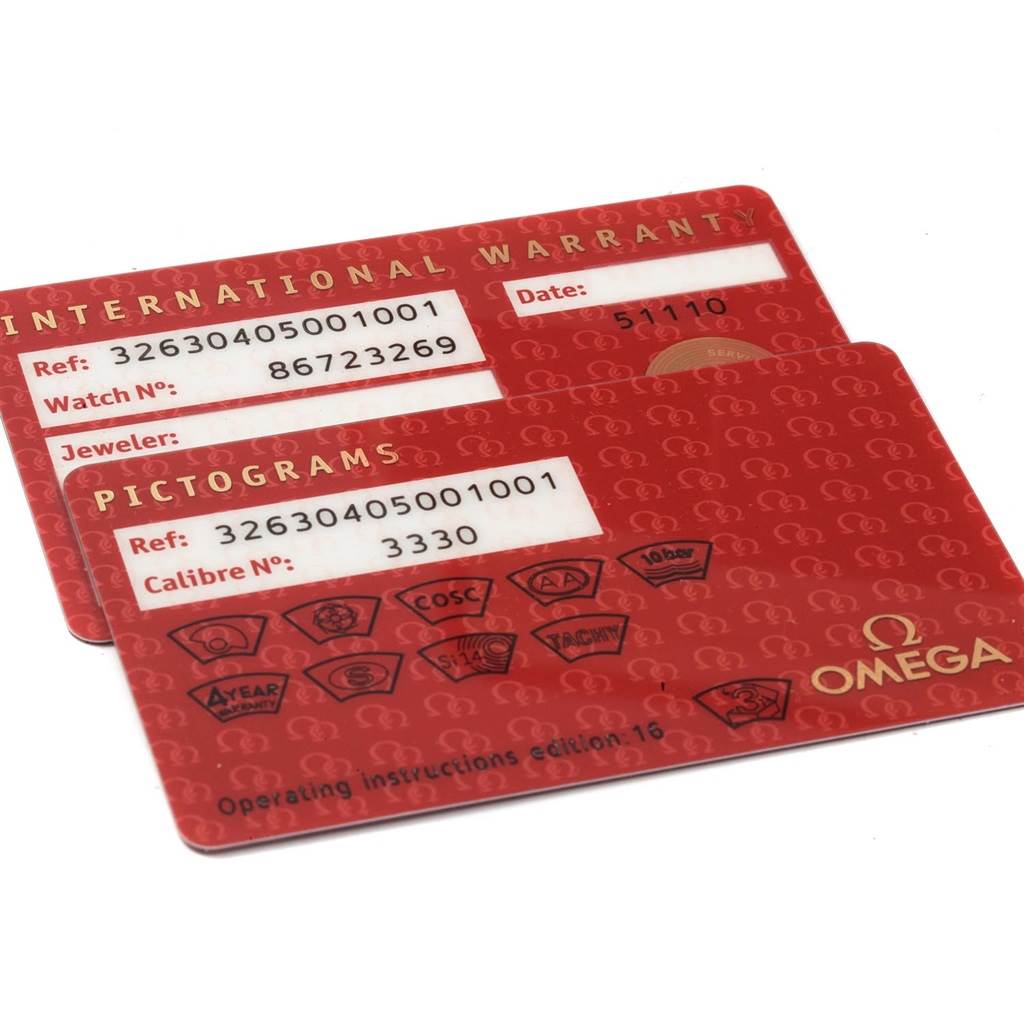 Two red international warranty and pictogram cards for the Omega Speedmaster 326.30.40.50.01.001 Men
s Stainless Steel Black Dial 326.30.40.50.01.001 Men
s Stainless Steel Black Dial watch are shown at an angled view.