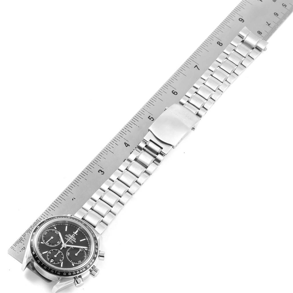 The Omega Speedmaster 326.30.40.50.01.001 Men
s Stainless Steel Black Dial 326.30.40.50.01.001 Men
s Stainless Steel Black Dial watch is shown from a top view, displaying its black dial and silver bracelet alongside a ruler for scale.