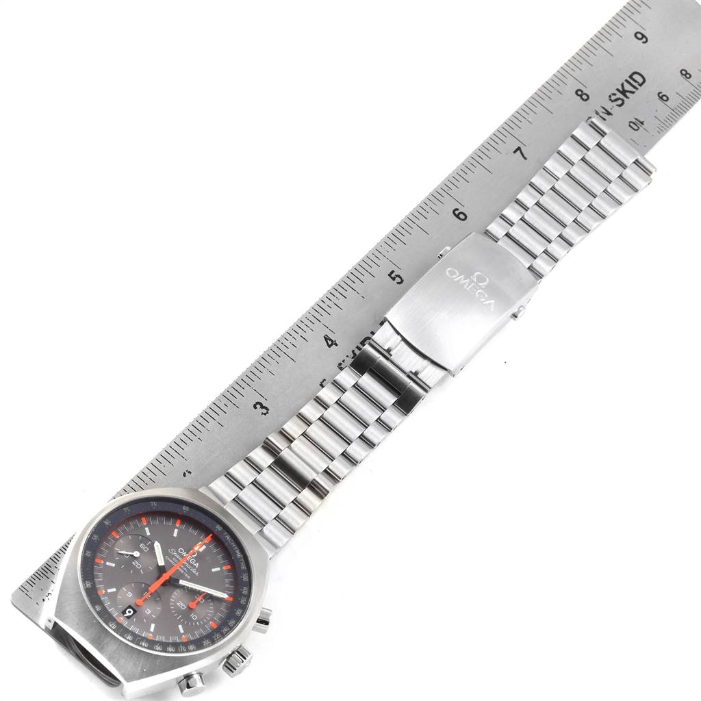 An Omega Speedmaster 327.10.43.50.06.001 Men
s Stainless Steel Grey Dial 327.10.43.50.06.001 Men
s Stainless Steel Grey Dial watch is displayed flat, showing the face and the full bracelet against a ruler.