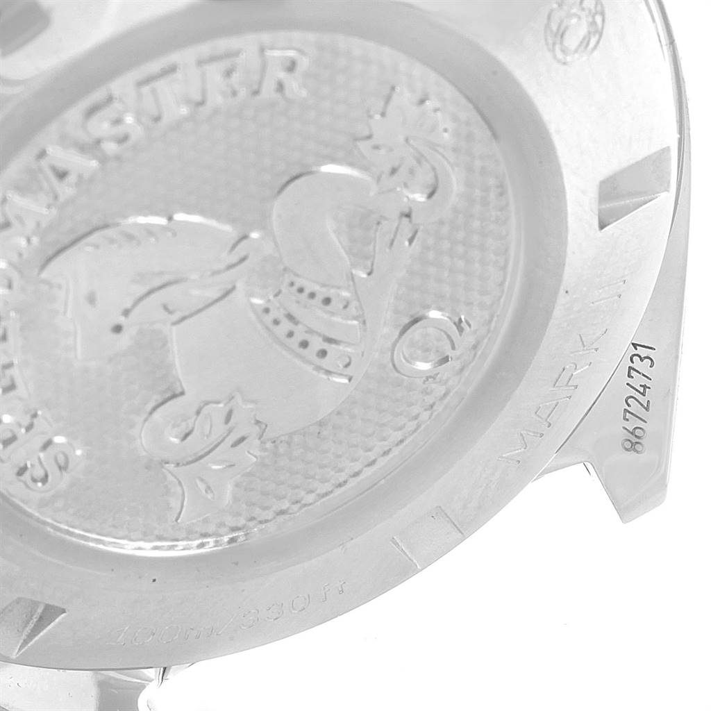 The image shows the back case of an Omega Speedmaster 327.10.43.50.06.001 Men
s Stainless Steel Grey Dial 327.10.43.50.06.001 Men
s Stainless Steel Grey Dial Mark II watch with engravings and stamped designs.