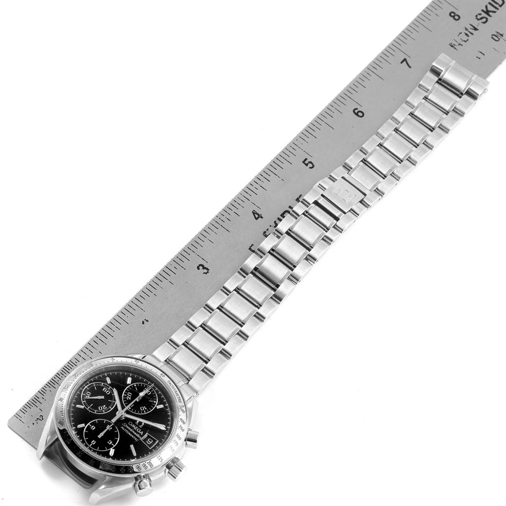 The image shows an Omega Speedmaster 3513.50.00 Men's Stainless Steel Black Dial 3513.50.00 Men's Stainless Steel Black Dial watch from a top-down angle, including the watch face and metal bracelet alongside a 7-inch ruler.